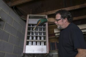 Repairman Cleaning Gas Furnace Pilot Light